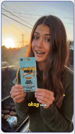 Woman holding a Cheddr cannabis product in a sunset UGC video