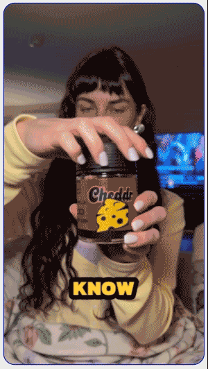 Customer reviewing a black Cheddr cannabis jar in a UGC video